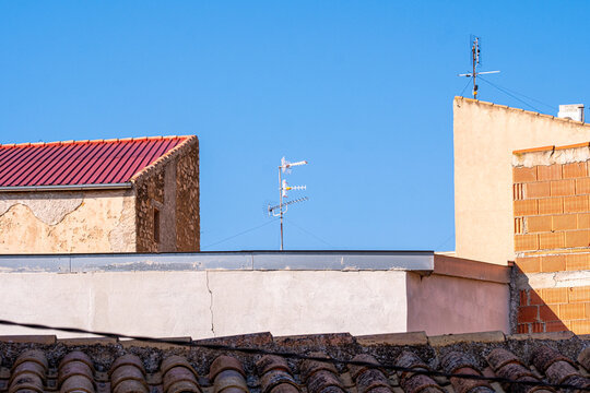 Minimalist architectural fragments with intersecting brick and plaster walls under vibrant blue sky, highlighting geometric abstraction and urban composition, modern city architecture concept