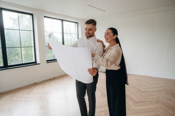 Guidance by the plan. Man and woman are in the modern new room, conception of business