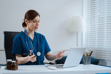 Caring therapist conducts video consultation, communicates with patient via an online conference,...