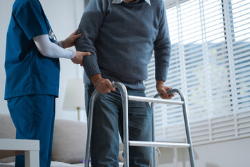 physiotherapist taking care of the happy senior patient in a medical clinic