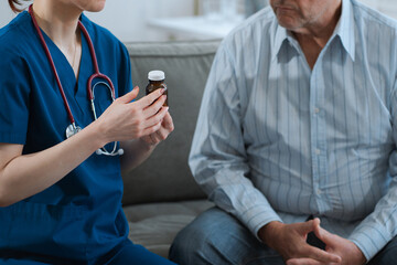 female therapist gives medication advice to a senior old patient in a medical clinic. therapy,...