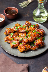 Chicken wings in teriyaki sauce with sesame and onion. Asian food.