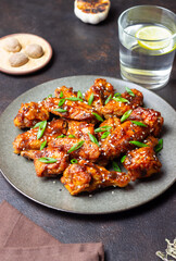 Chicken wings in teriyaki sauce with sesame and onion. Asian food.
