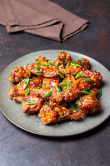 Chicken wings in teriyaki sauce with sesame and onion. Asian food.