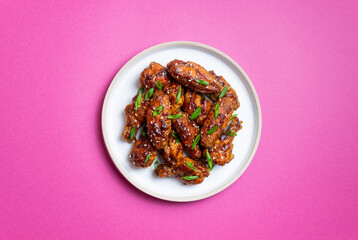 Chicken wings in teriyaki sauce with sesame and onion. Asian food.