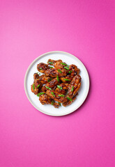 Chicken wings in teriyaki sauce with sesame and onion. Asian food.