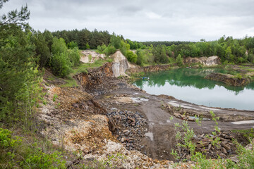 General view of partially flooded basalt quarry in overcast day