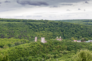 Fototapeta premium Castle ruins in forested bowl-shaped deepening in river valley