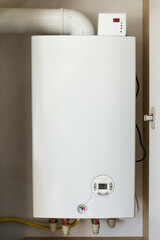 Installed household gas boiler hanging on the wall