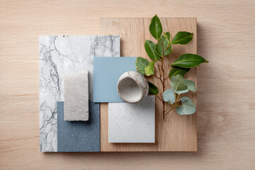 Kitchen Interior Design Mood Board. An interior design mood board for a kitchen featuring marble, wood, stone, and blue paint swatches, with a sprig of greenery.