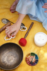 Calm hand arranges spiritual objects for meditation practice. Image is useful for illustrating mindfulness, wellness, or holistic lifestyle concepts.