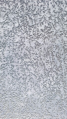 Stucco wall background texture with rough plaster and gradient from dark to light. Architectural...