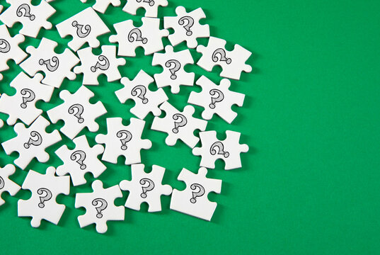 Question marked puzzle pieces on green background
