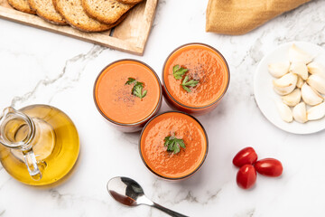 Top view of Gazpacho, Spanish cold tomato soup, served in glasses.