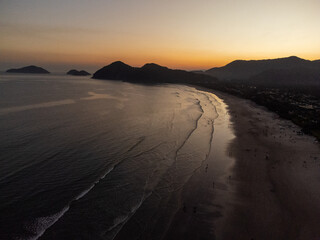 Incredible orange sunset on a beach in the middle of the forest