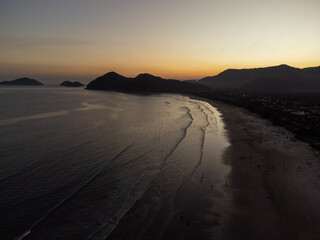 Incredible orange sunset on a beach in the middle of the forest