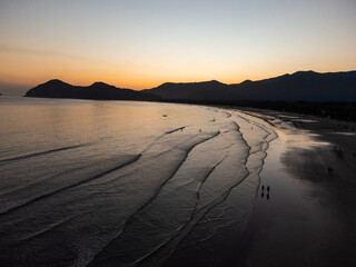 Incredible orange sunset on a beach in the middle of the forest