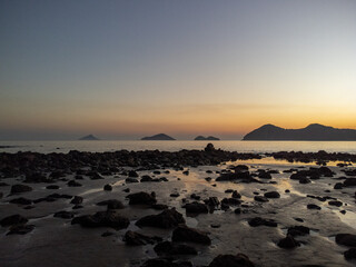 Fototapeta premium Incredible orange sunset on a beach in the middle of the forest
