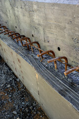 Close-up of a concrete construction joint with rebar dowels.
