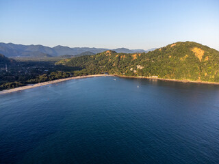 Sunset light on beach amidst mountains