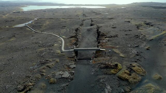 aerial of The Bridge between Continents footbridge spanning a rift between the Eurasian and North American tectonic plates warm sunshine