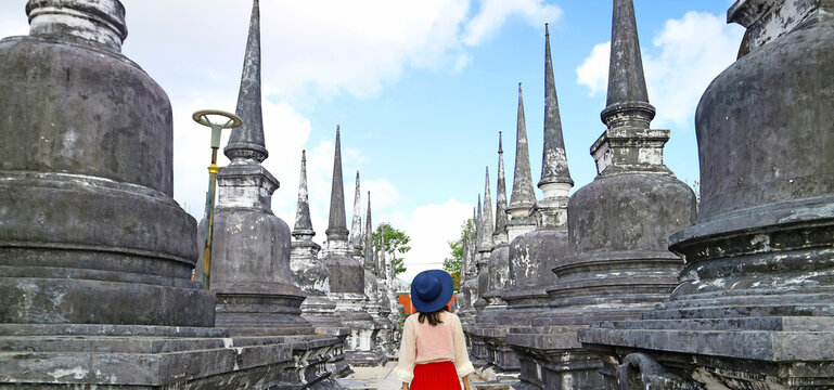 Visitor Walking Amongst the Rows of Minor Stupas of Wat Phra Mahathat Woramahawihan Buddhist Temple, Nakhon Si Thammarat, Thailand