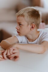 Young mother helps her hard-of-hearing son with schoolwork at home. A natural, heartfelt moment of...