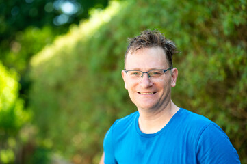 Portrait of a 46 yo man with glasses against a green background in Ternat, Flemish Brabant, Belgium