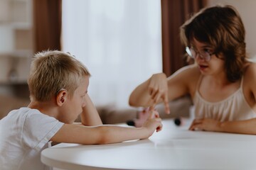 Young mother helps her hard-of-hearing son with schoolwork at home. A natural, heartfelt moment of...