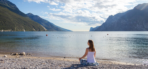 Woman meditating at the lake