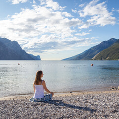 Woman meditating at the lake