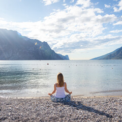Woman meditating at the lake