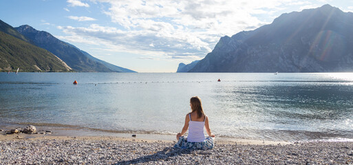 Woman meditating at the lake