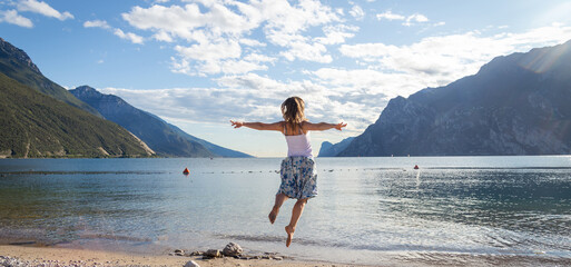 Woman jumping at the lake