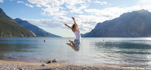 Woman jumping at the lake