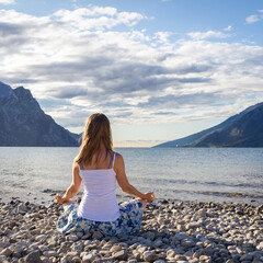 Woman meditating at the lake