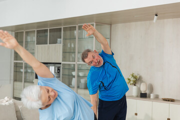 Obraz premium Fitness training. Senior mature healthy fit couple doing sports exercise at home. Mid age husband wife have training workout. Health care healthy lifestyle. Workout rehabilitation for old man woman