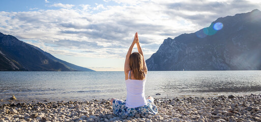 Woman meditating at the lake