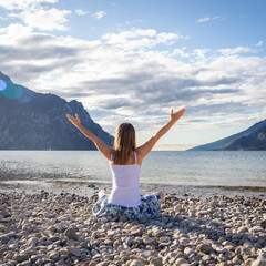 Woman meditating at the lake