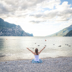 Woman meditating at the lake