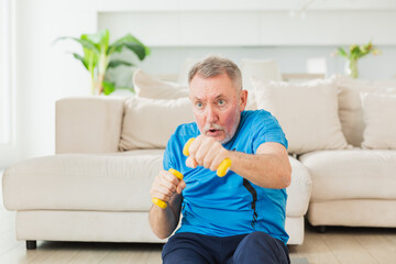 Fitness workout training. Senior man boxing punching picking up dumbbells. Old adult mature healthy...