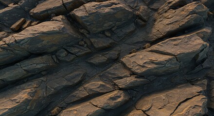 Closeup of layered cracked dark grey and brown rock formation with strong angular features