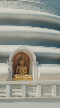 Japanese Peace Temple In Rumassala, Galle, Sri Lanka. Close up Famous landmark and cultural sacred place. The golden statue of Lord Buddha in Parinirvana, Japanese Peace Pagoda. View of the Japanese