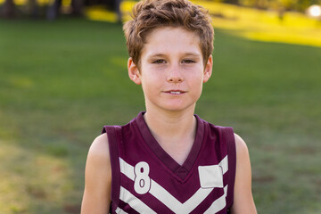 head and shoulders of schoolboy wearing sleeveless football jersey