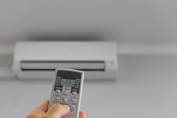 Air Conditioning Remote Control, Air Conditioner Hanging On White Wall Under Ceiling, Repair