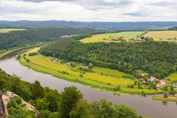 Königstein, Germany – June 5, 2025: Scenic view from the historic fortress Königstein overlooking lush forests and distant hills in Saxon Switzerland under a dramatic cloudy sky