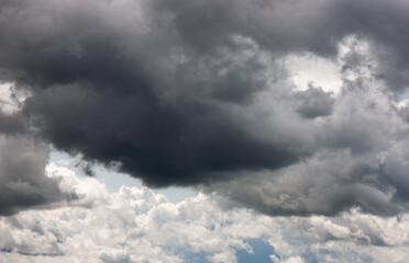 Dark storm clouds with rain. Storm clouds of various soft shapes in the sky. Changeable weather....
