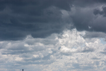 Dark storm clouds with rain. Storm clouds of various soft shapes in the sky. Changeable weather....