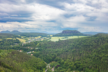 Königstein, Germany – June 5, 2025: Scenic view from the historic fortress Königstein overlooking lush forests and distant hills in Saxon Switzerland under a dramatic cloudy sky