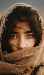 Close-Up Portrait of a Young Woman with Freckles Wearing a Brown Scarf